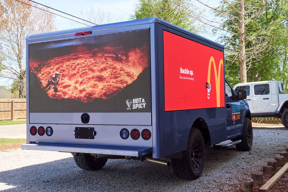 mobile LED truck displaying advertisements for KFC and McDonald's